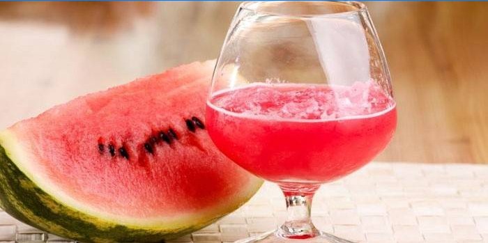 Vandmelon tinktur på vodka i et glas og en skive vandmelon