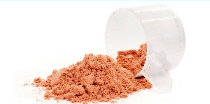 Glutaminpulver i en måleske
