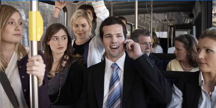 En mand, der taler i telefonen i en bus